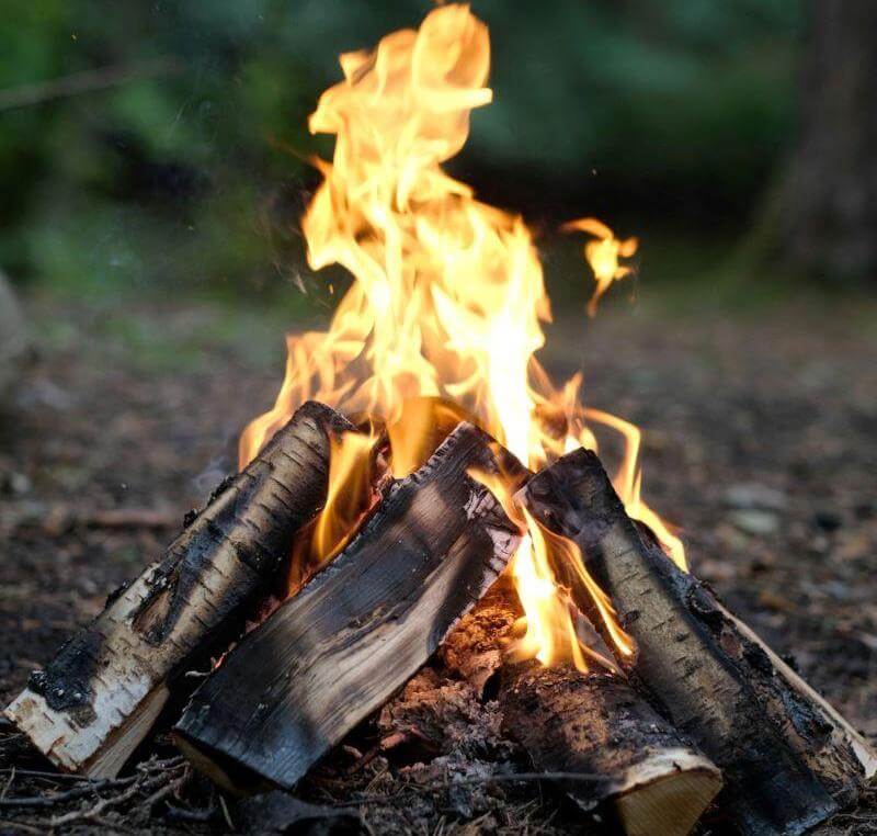 A well-built campfire does not burn out quickly.  Stack logs in a triangular fashion to keep the fire buring efficiently for campfire cooking.
