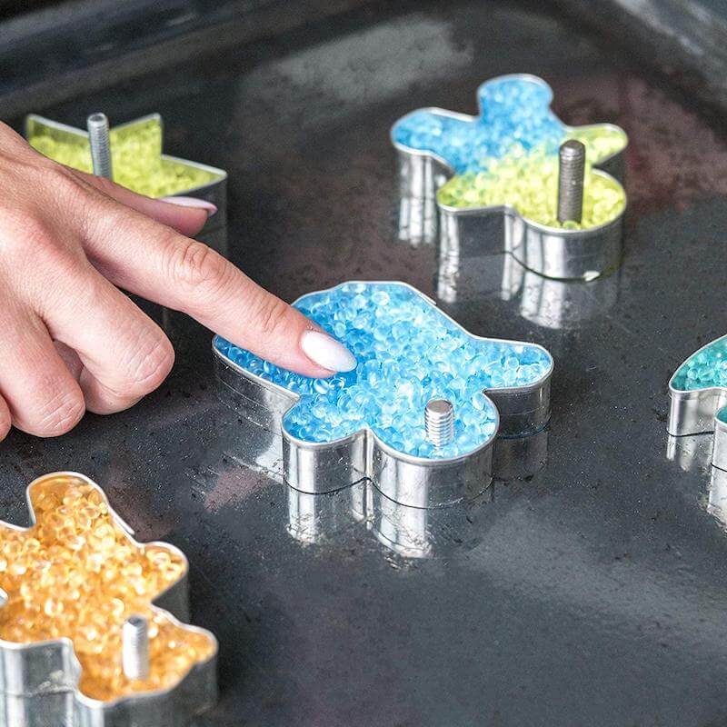 Press the scent beads into the cookie cutter.  Use a screw or something similar to create a hole at the top of each mold so that they can be hung by a string.
