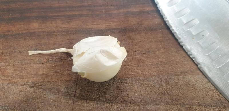 The skin of the garlic clove just lifts away, usually in one piece.