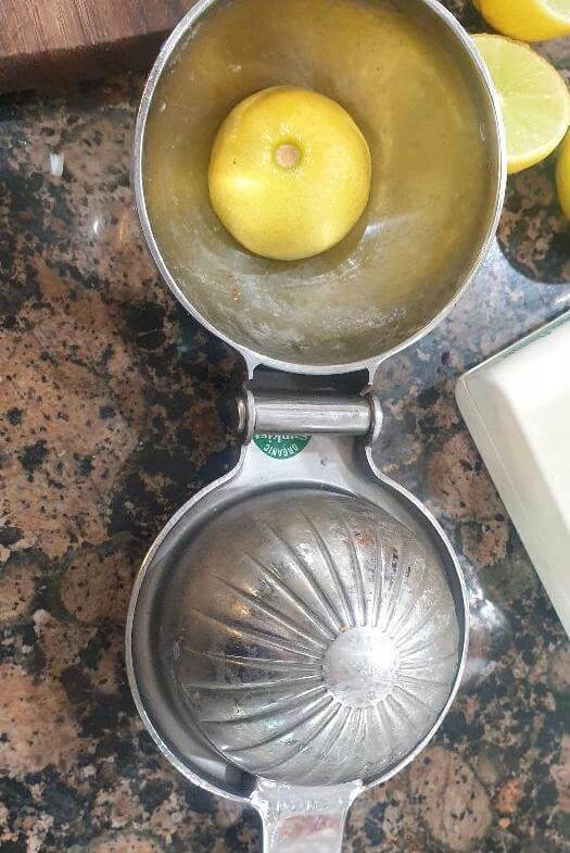 Squeeze the fresh juice of the lemon into the food processor with the chopped garlic.
