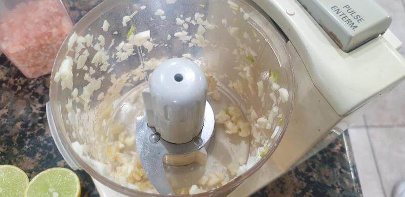 Let the food processor chop the garlic cloves into tiny pieces.
