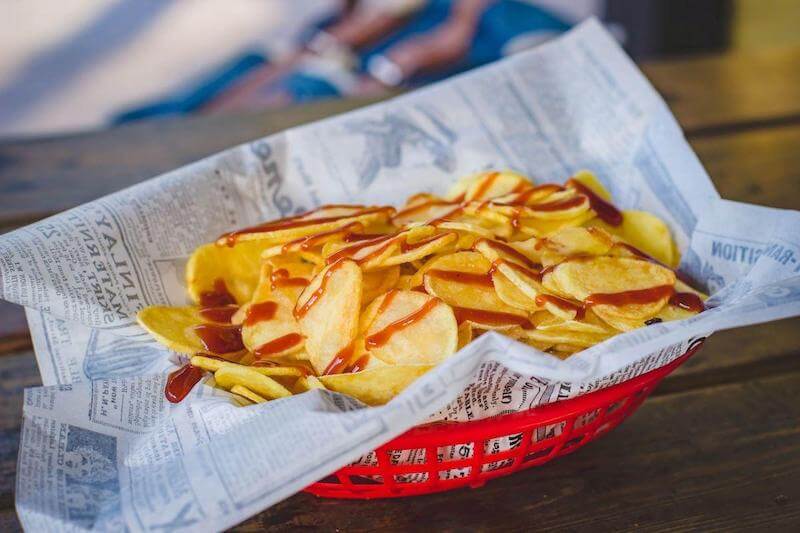 Sprinkle your homemade salt and vinegar powder on the chips while they are still hot.  Top with an optional squeeze of BBQ sauce.
