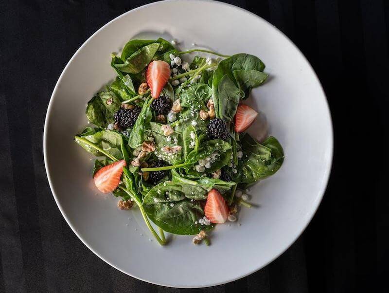 A spinach salad with berries is a great example of a chlorophyll and antioxidant rich meal that Dr. Hazel Parcells encouraged. 