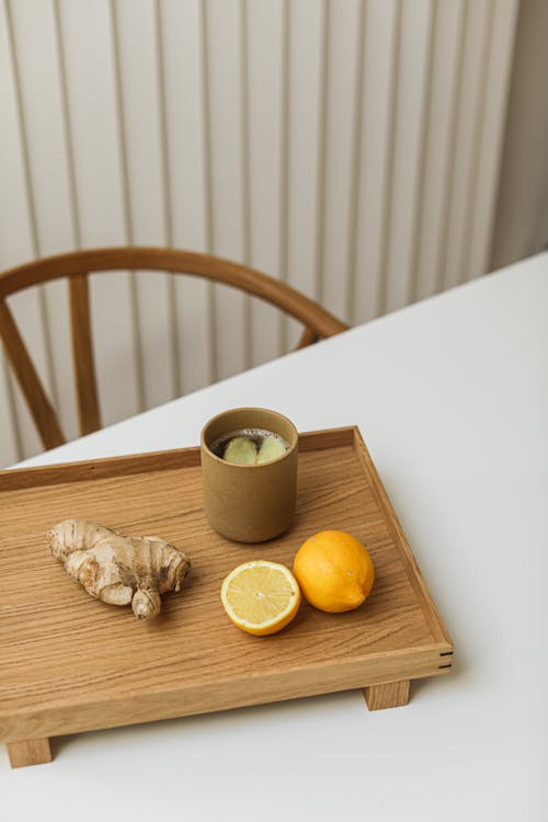 Cozy cup of lemon balm tea on wooden tray for evening relaxation
