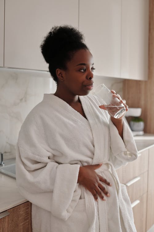 woman preparing food grade diatomaceous earth for detox in kitchen