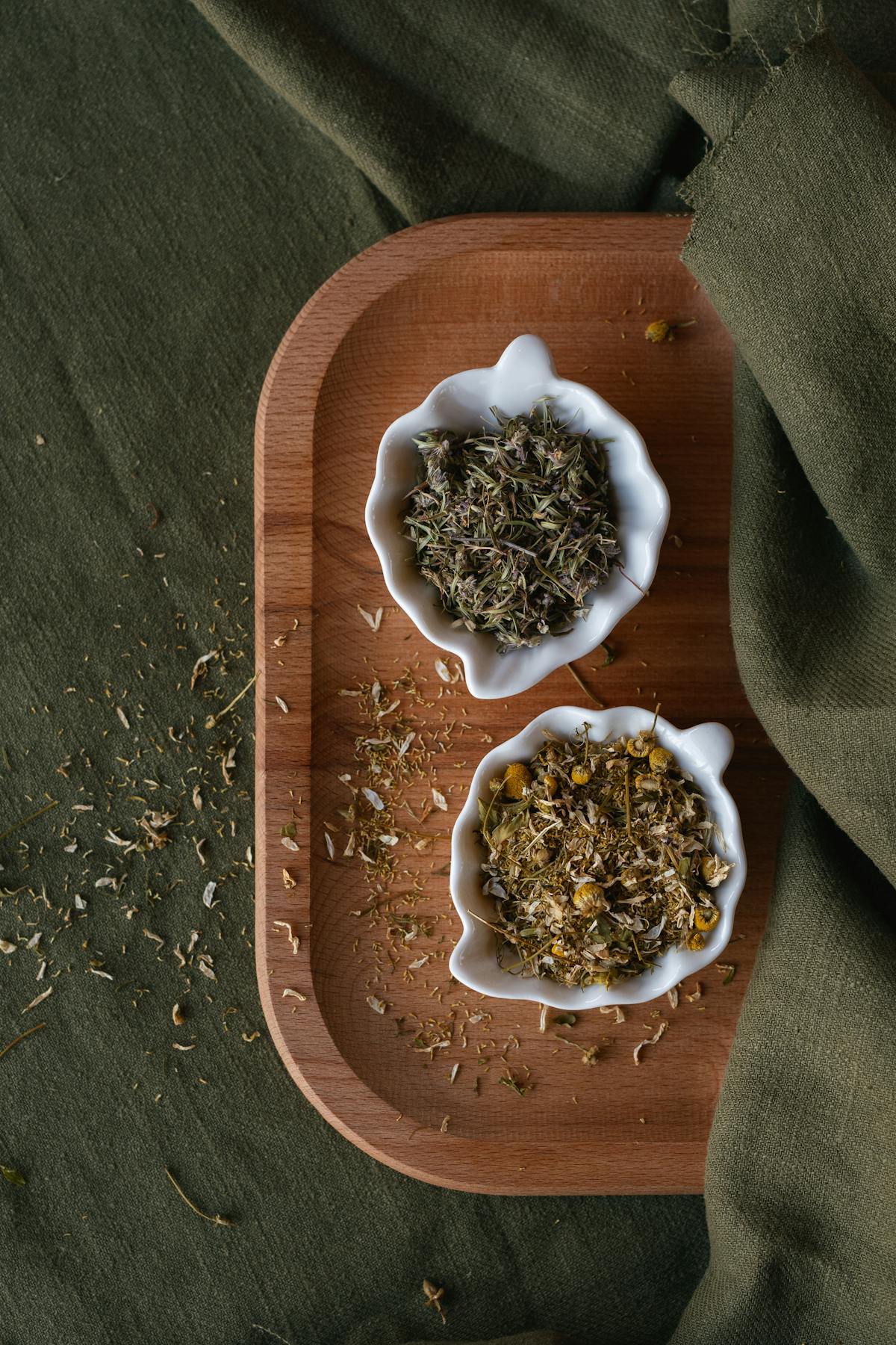 Dried mullein leaves and herbs in a small wooden bowl