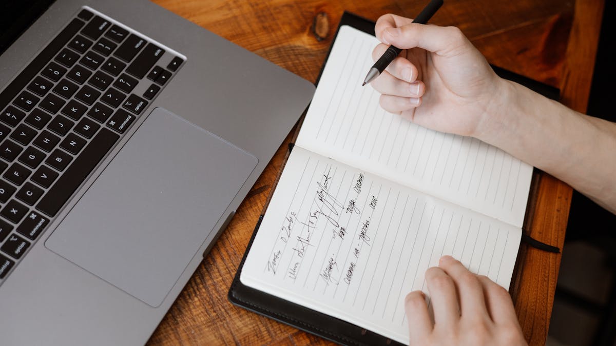 Clean desk with open notebook, pen, and no phone in sight, set up for focused work