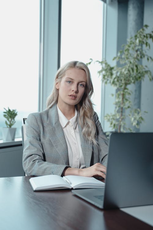 Person writing at desk with focus and concentration