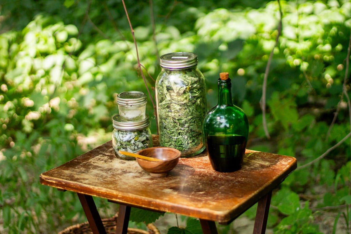 apothecary jars of herbs used in digestive bitters for bloating