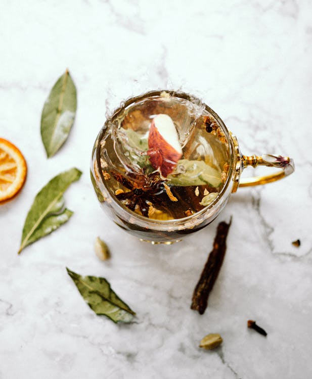 Cup of herbal tea with dried herbs for marshmallow root gut health