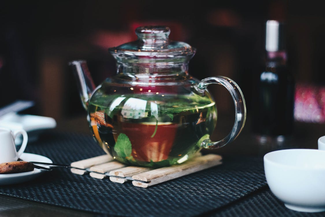 Glass teapot with herbal lemon balm tea for anxiety and sleep