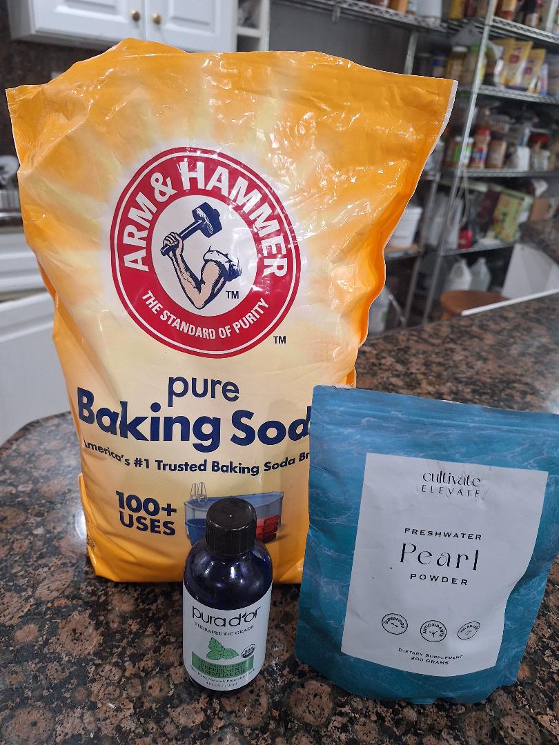 The three ingredients in my DIY pearl powder toothpaste: Arm & Hammer baking soda, Pura d'or peppermint essential oil, and Cultivate Elevate Freshwater Pearl Powder
