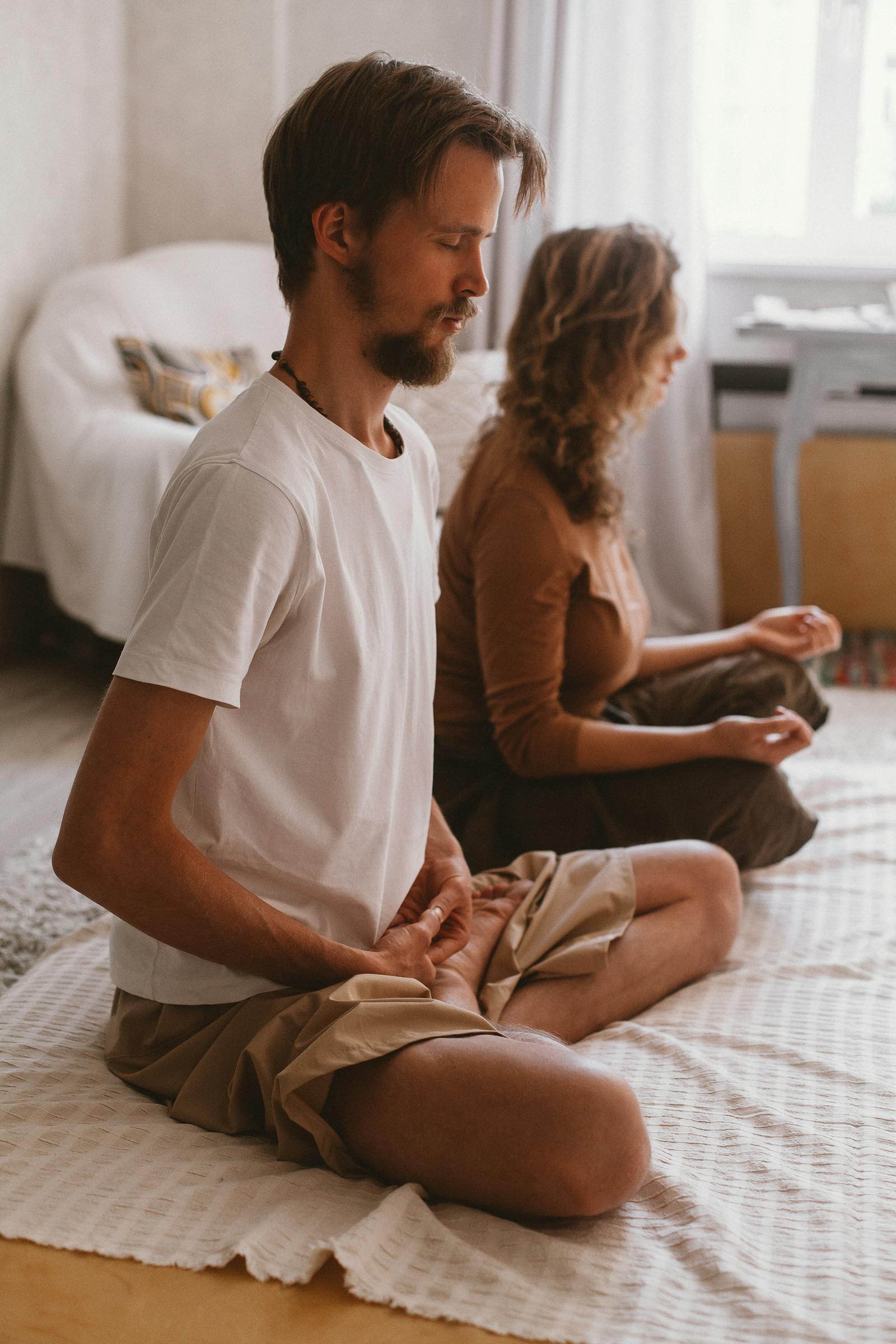 A couple practicing calm breathing together in a sunlit room
