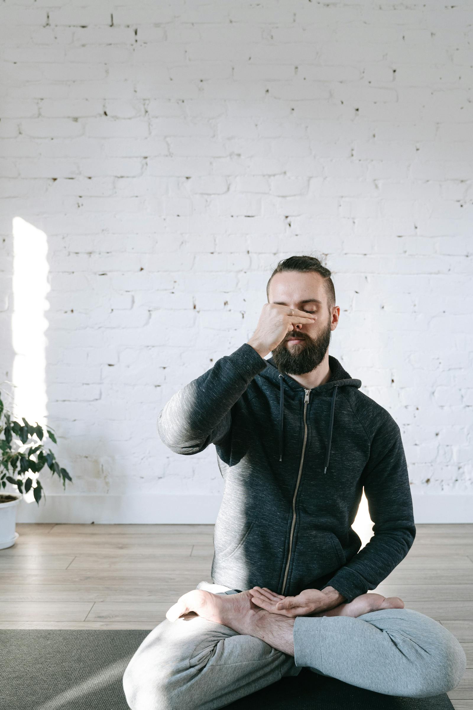 Person practicing the box breathing technique for stress in a seated yoga pose