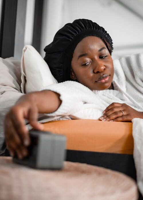 Woman waking up as part of morning routine for habit stacking