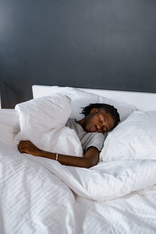 Person sleeping peacefully showing the importance of consistent sleep for nervous system health