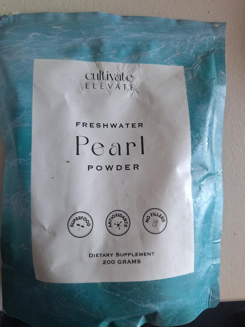 Cultivate Elevate freshwater pearl powder bag on my bathroom vanity counter, the brand I reorder and keep within arm's reach