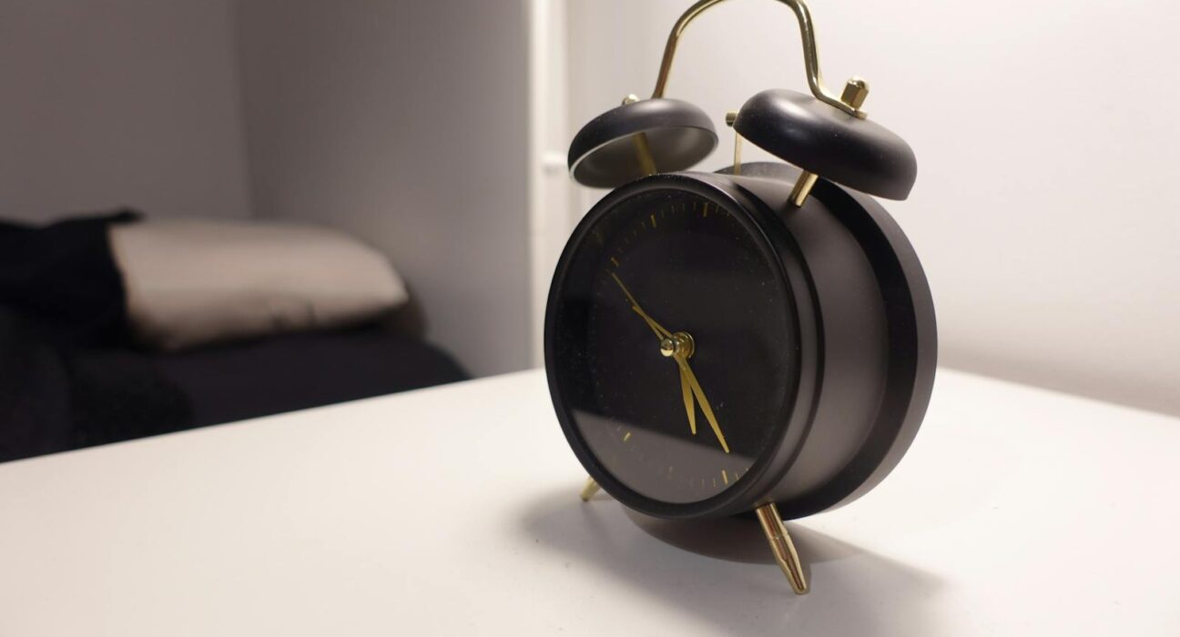 phone free mornings analog alarm clock on minimalist bedside table