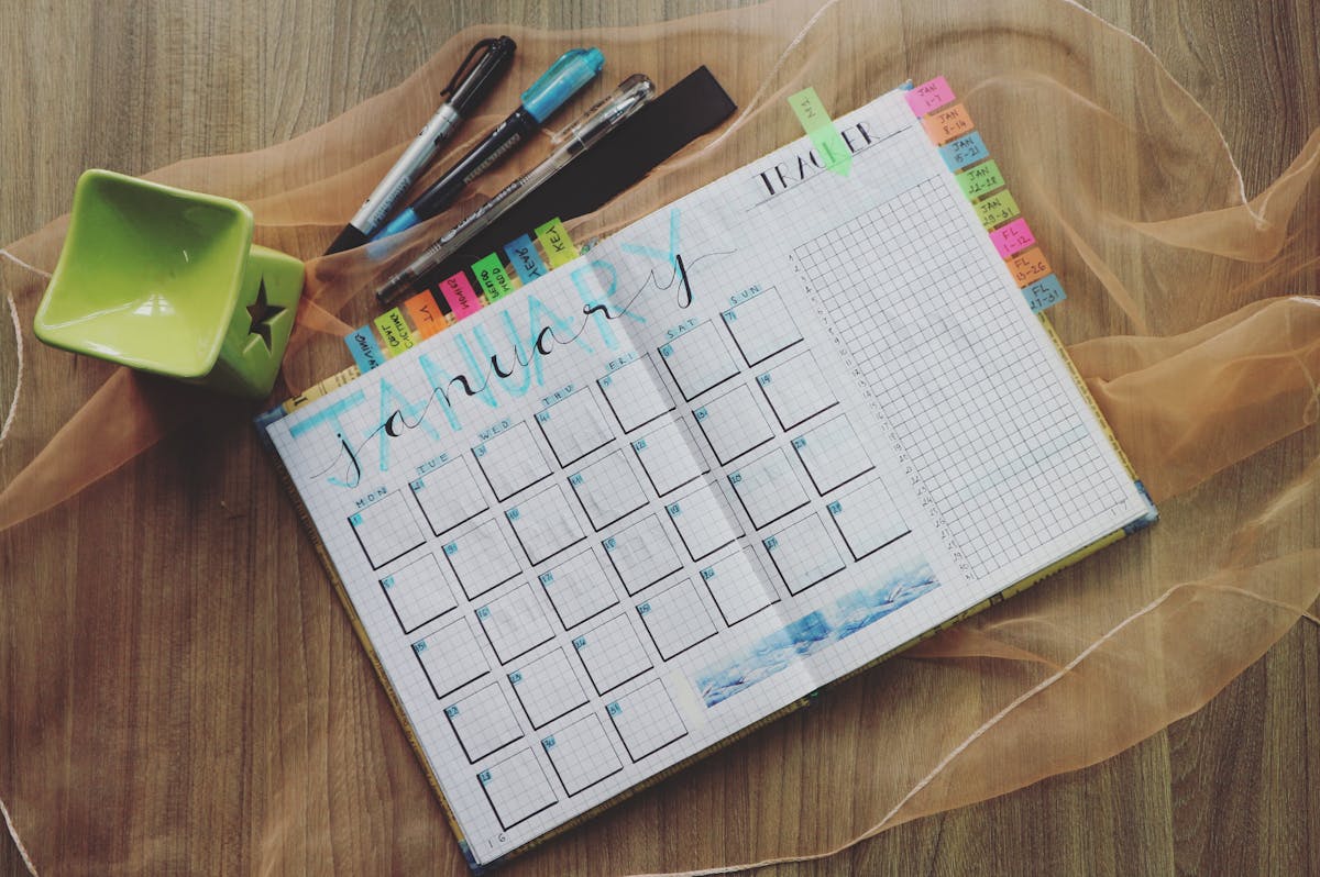 A simple time blocking workspace with a notebook and small timer