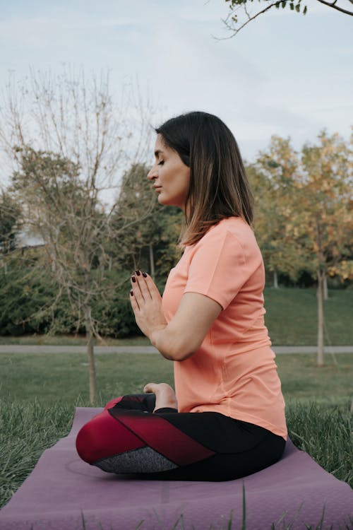 Woman practicing deep breathing exercises outdoors for nervous system regulation