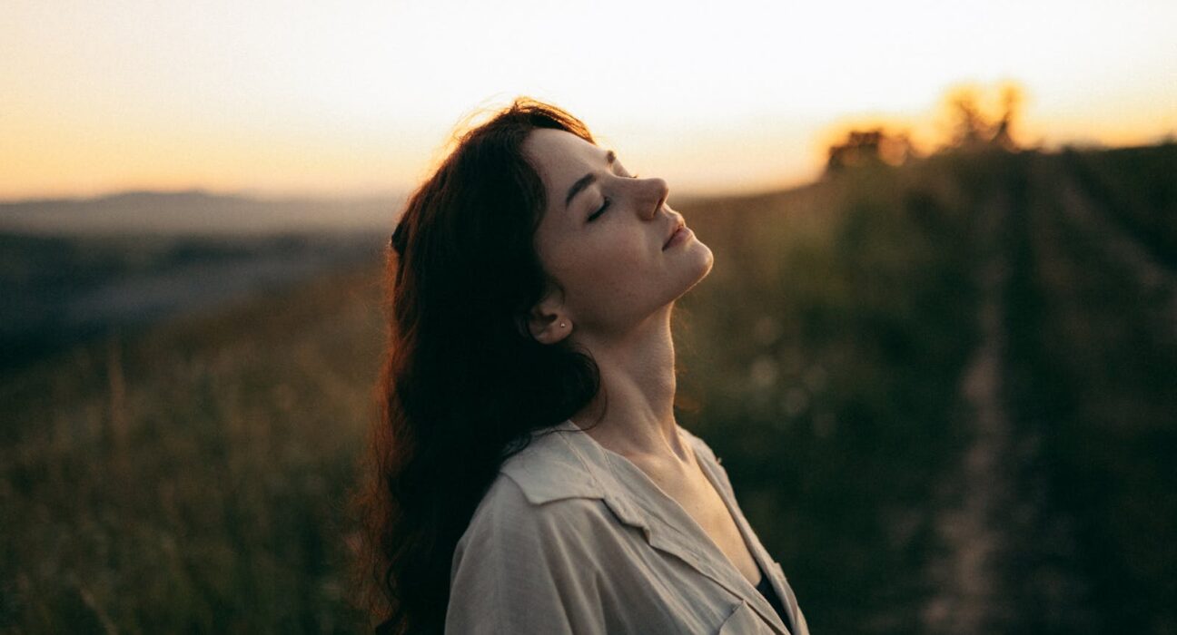Woman feeling refreshed outdoors after natural allergy relief
