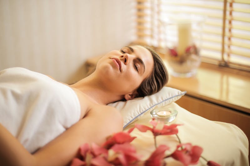 woman relaxing during castor oil pack self care routine
