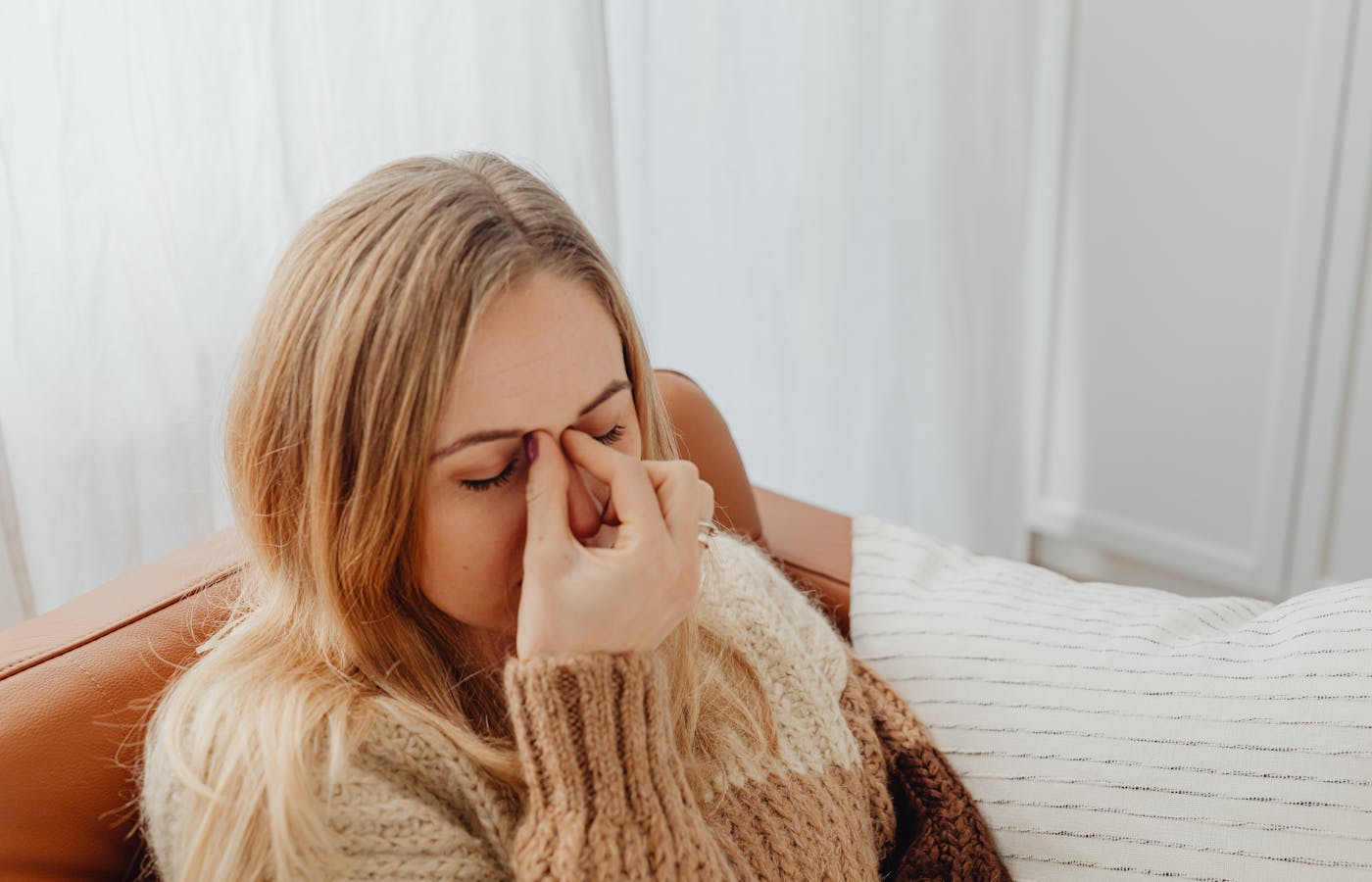 Woman holding her face with sinus congestion and pressure pain