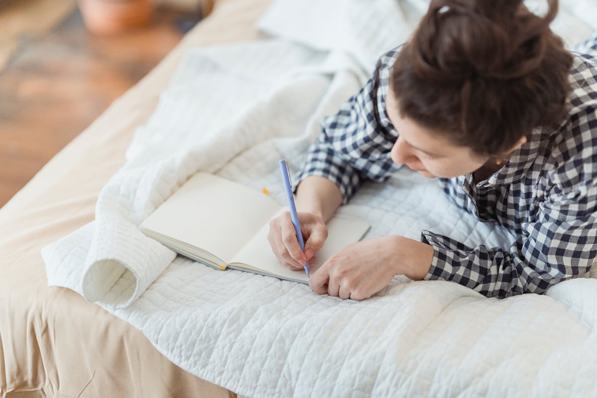 Woman writing in gratitude journal for mental health