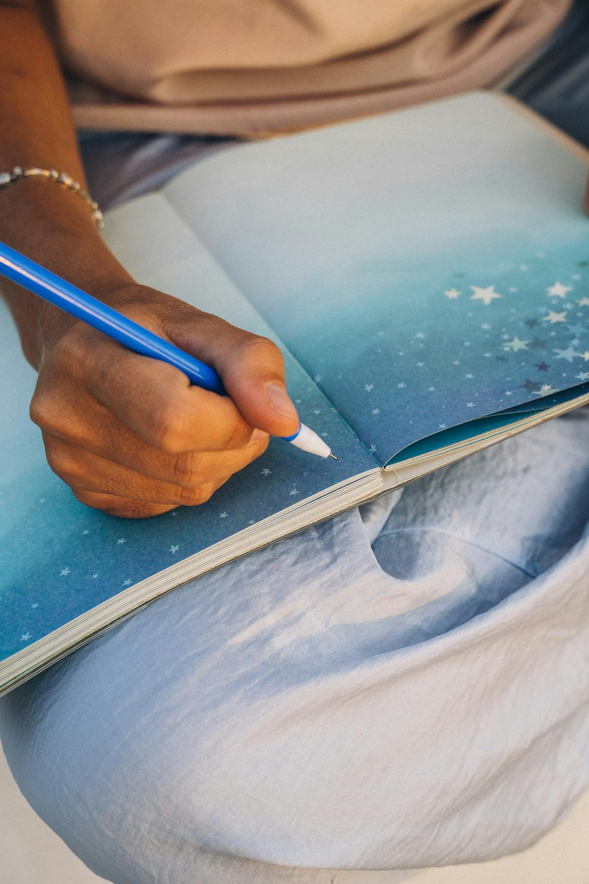 Hand writing reflections in a journal during a 5 minute gratitude practice