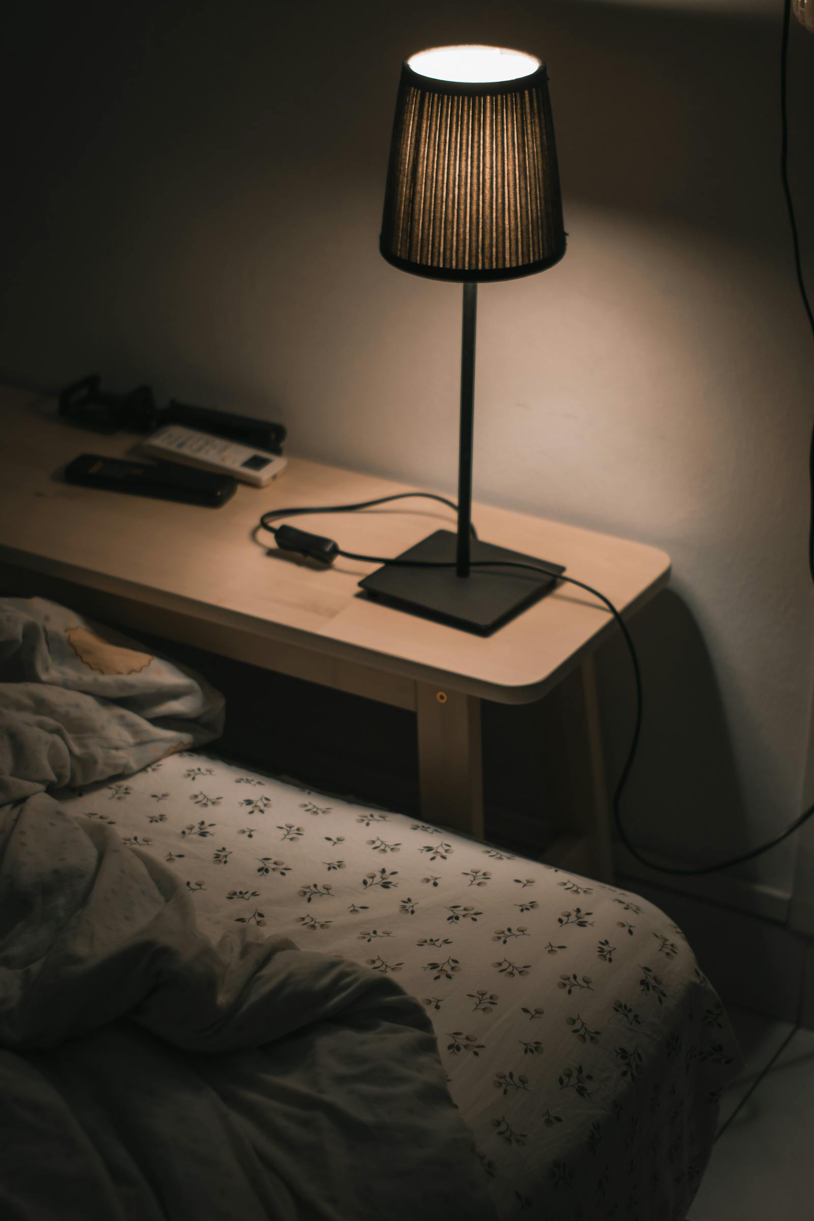 Cozy bedroom with warm bedside lamp set for restful sleep