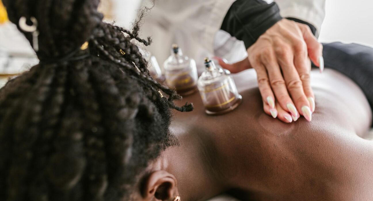 Woman receiving soothing cupping therapy on her back in a serene spa setting