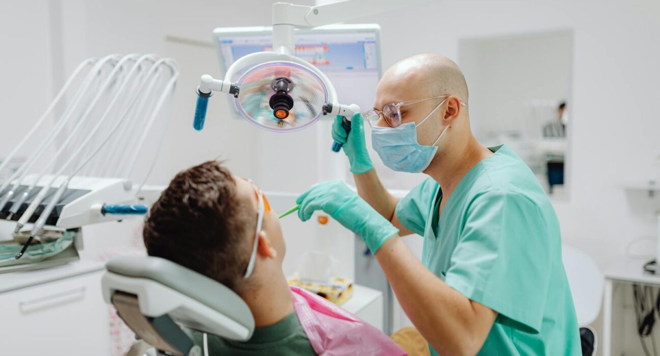 Holistic dentist performing dental bridge consultation in a modern clinic