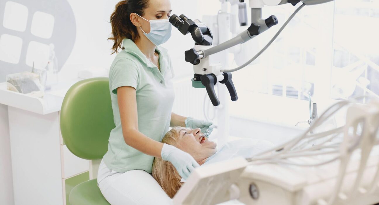 Holistic dentist examining a tooth before crown placement in a modern clinic