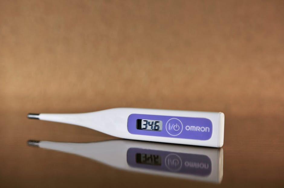 thermometer checking for fever to differentiate stomach bug from food poisoning