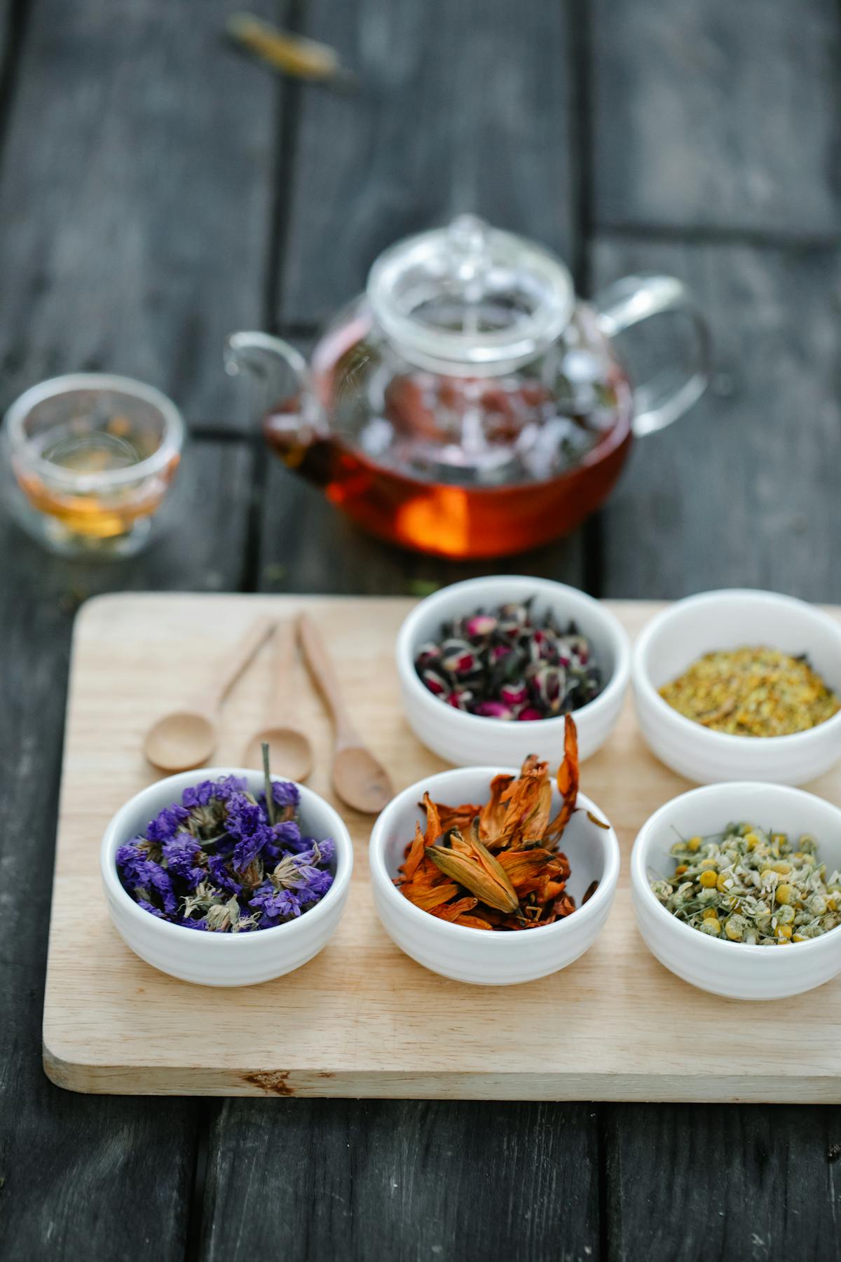Dried herbs and flowers in jars used for natural remedy preparation