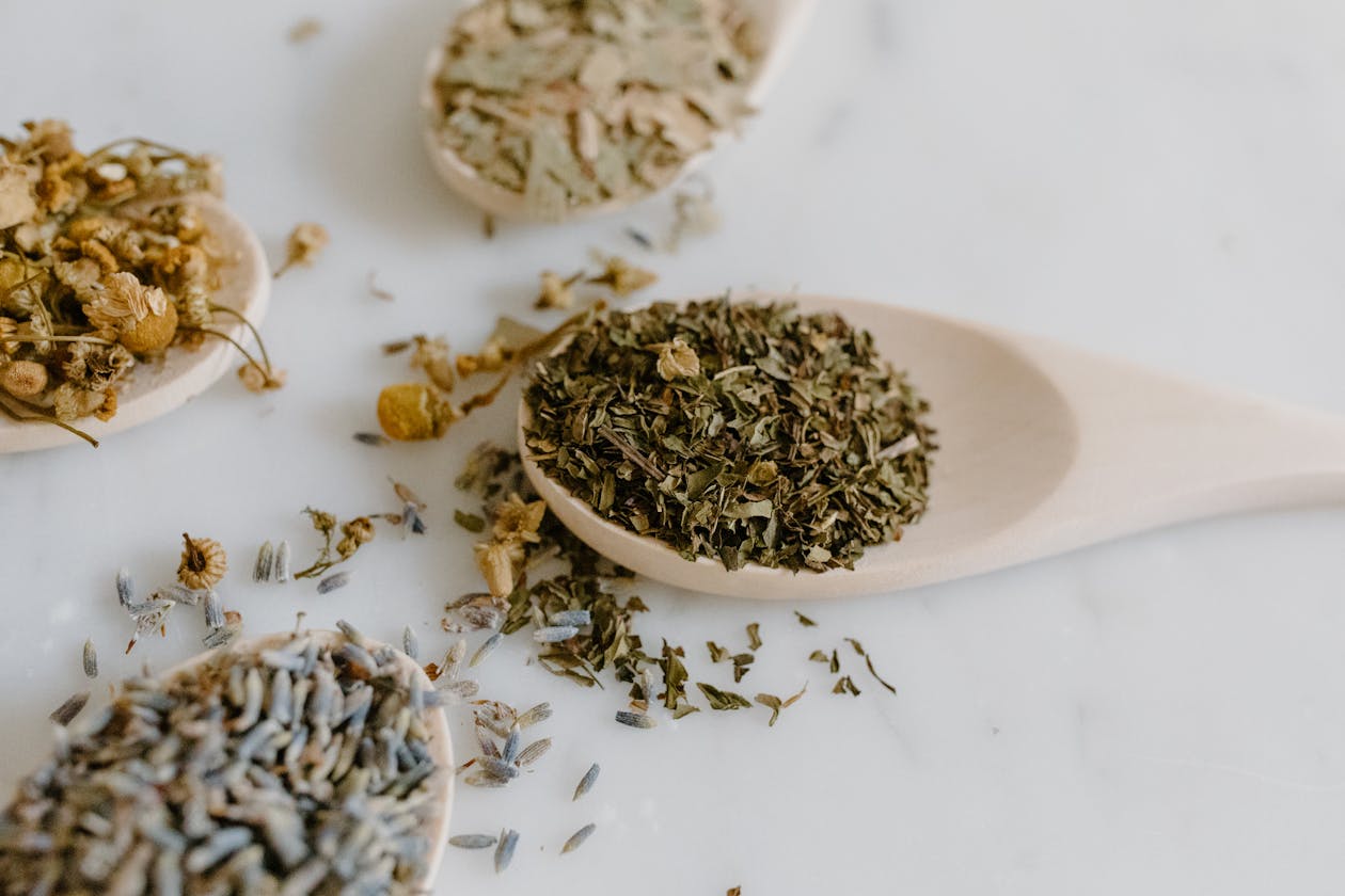 dried herbal supplements on wooden spoons illustrating natural mineral support