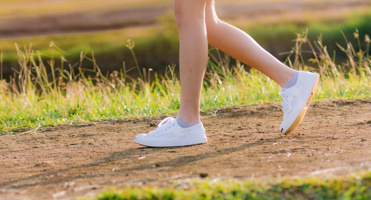 Woman walking outdoors representing walking to lose weight protocol