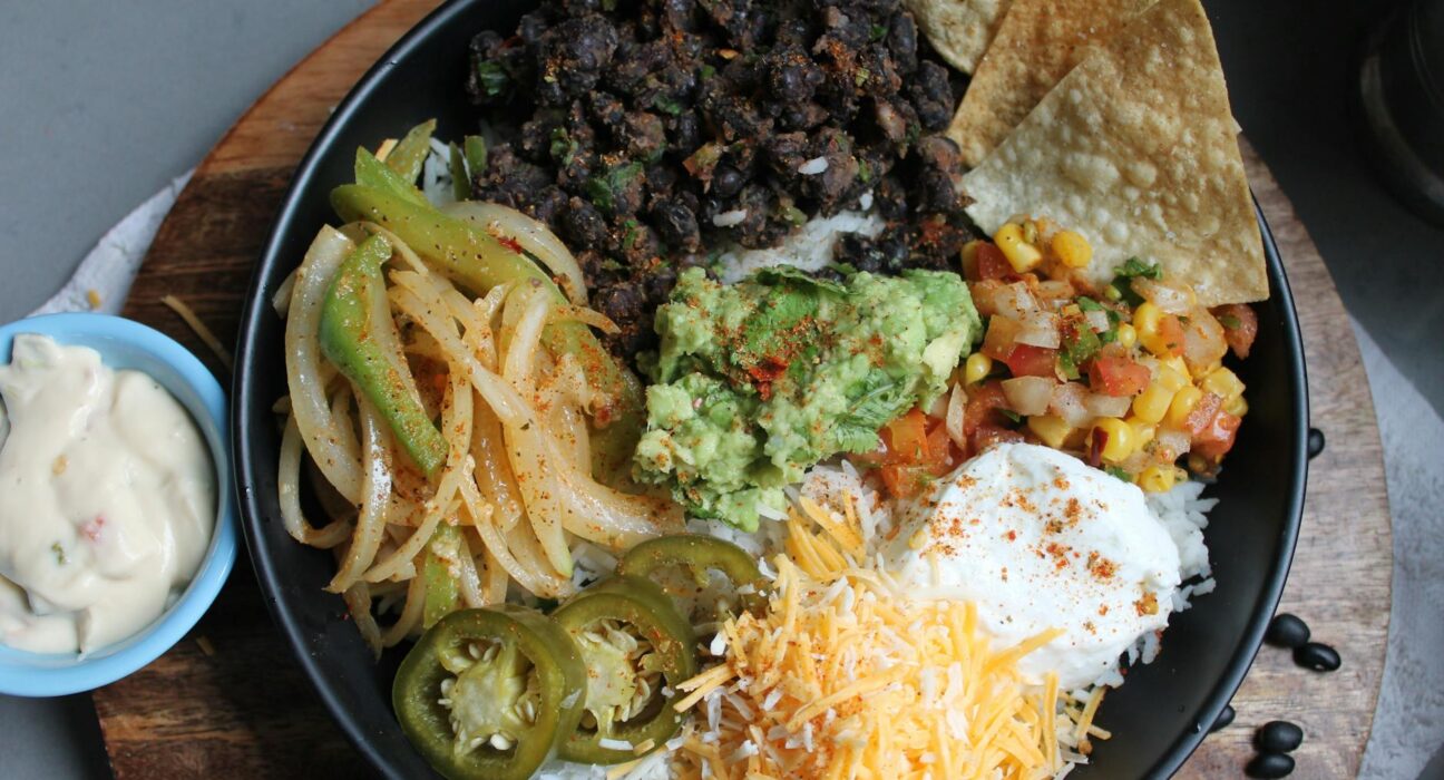 Chipotle-style burrito bowl with rice, chicken, beans, salsa and guacamole