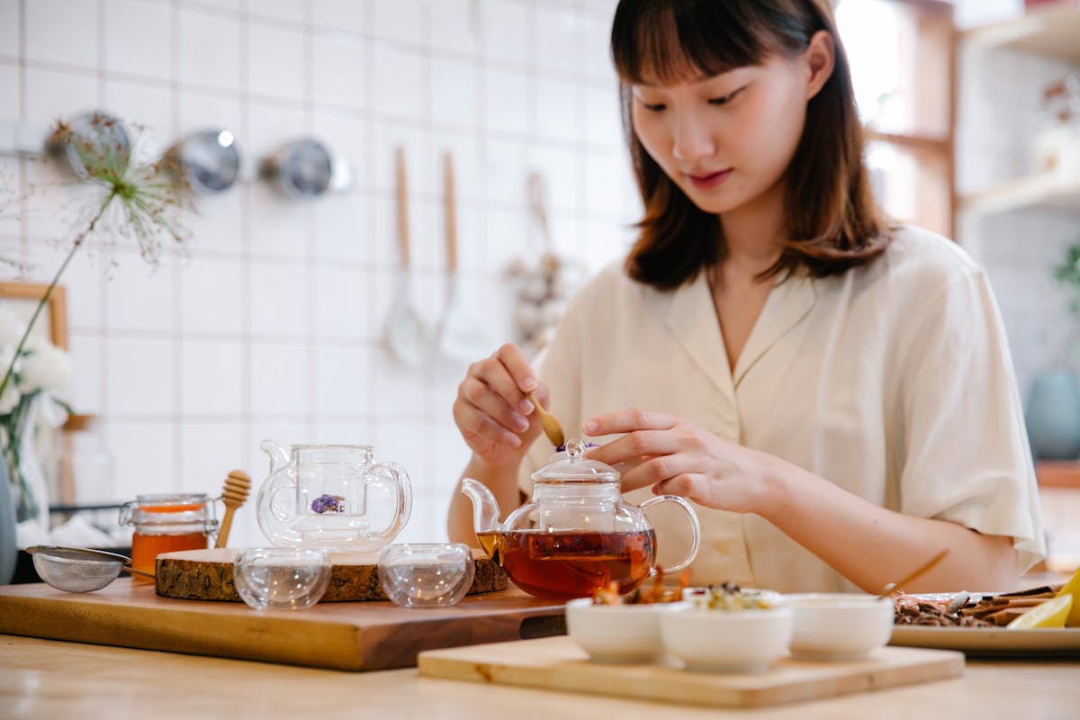 Brewing herbal cleansing tea in modern kitchen for parasite cleanse at home