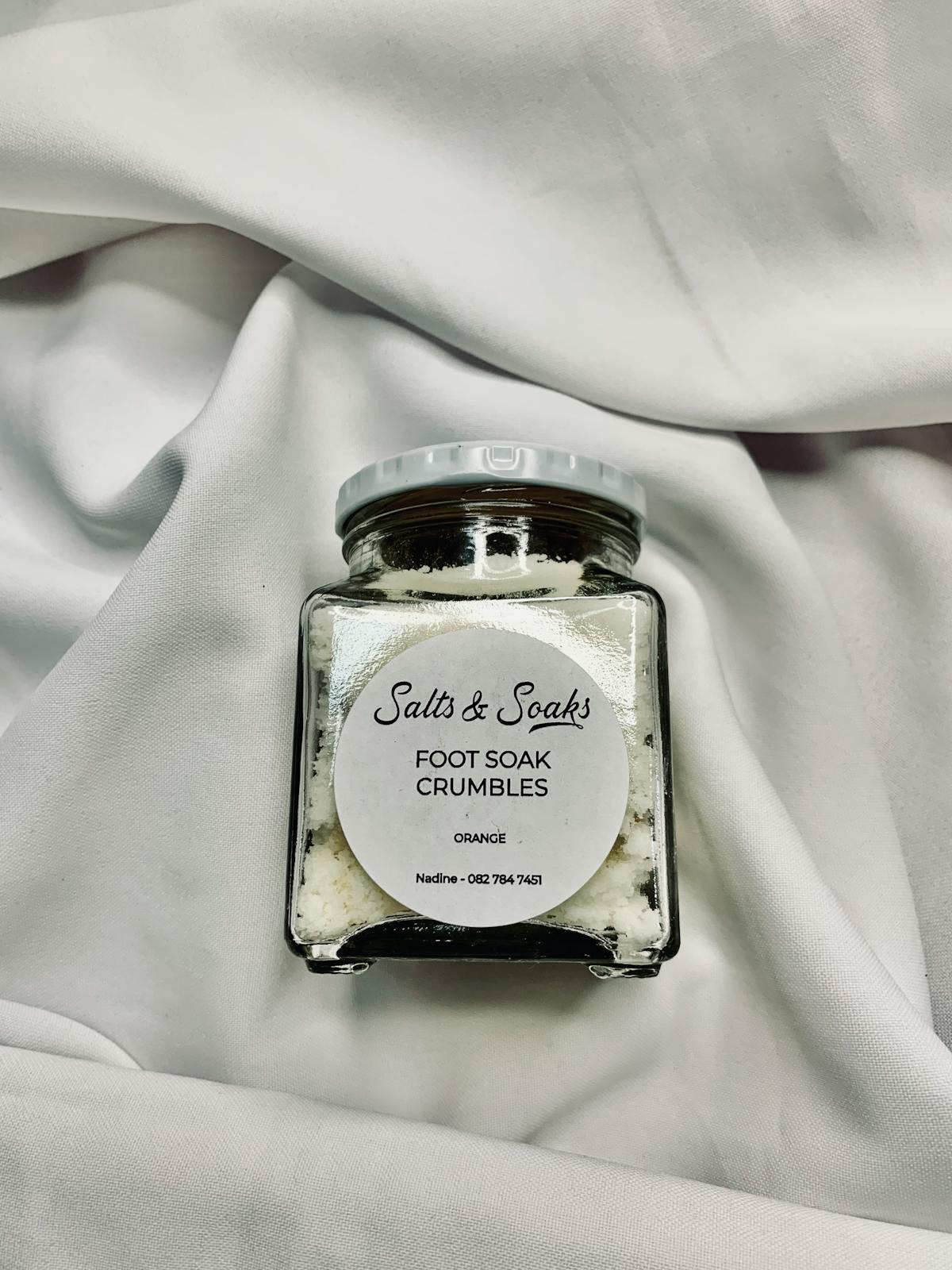 Epsom salt foot soak crumbles in a glass jar