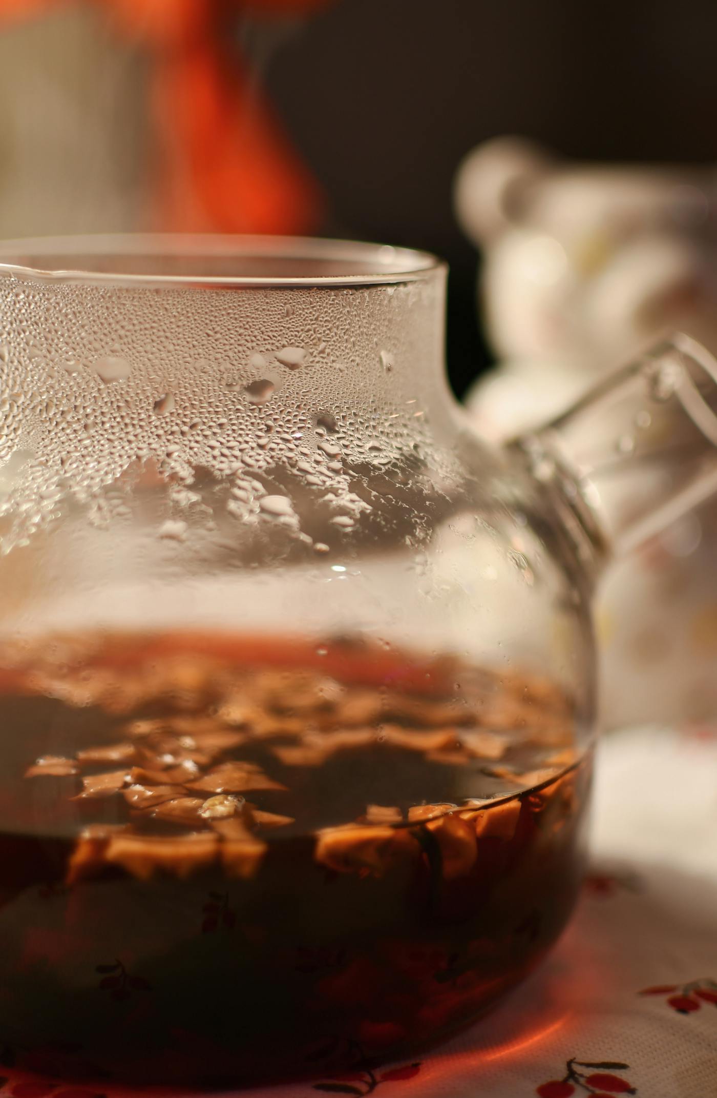 Glass teapot brewing burdock root tea infusion