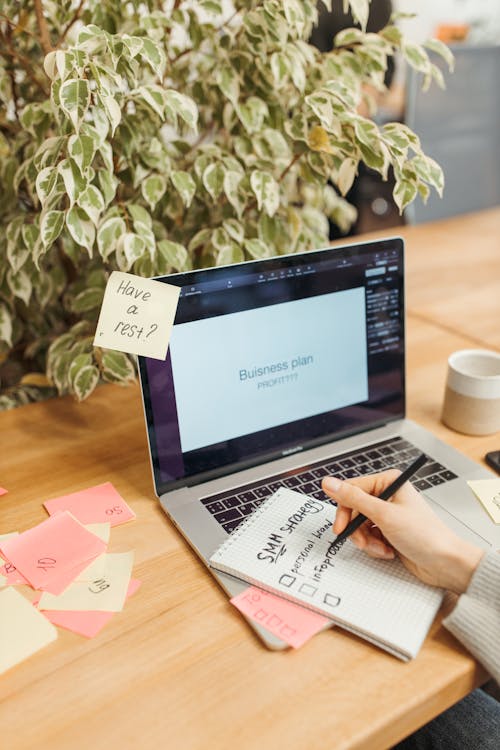 person writing daily tasks using the 1-3-5 rule for productivity