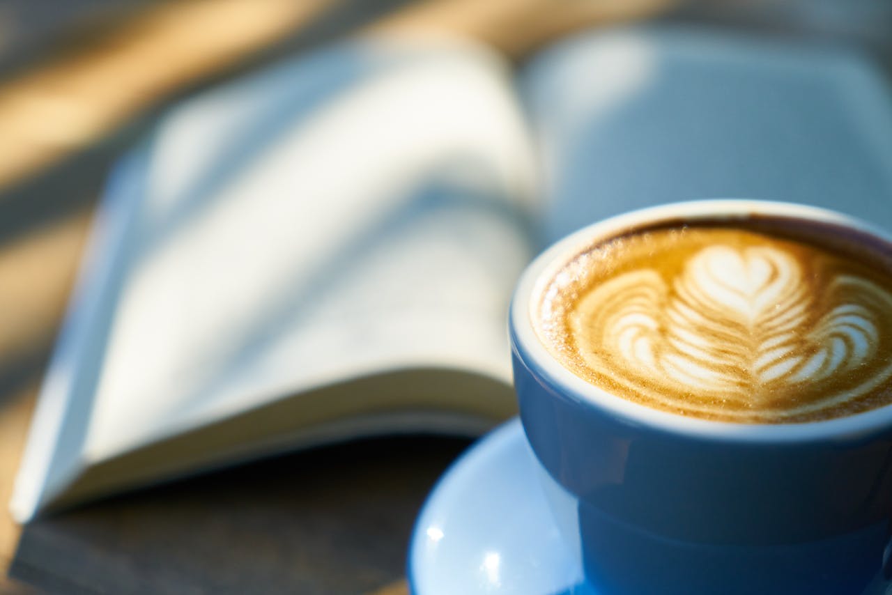 An open book and morning latte, a simple anchor for a daily reading habit