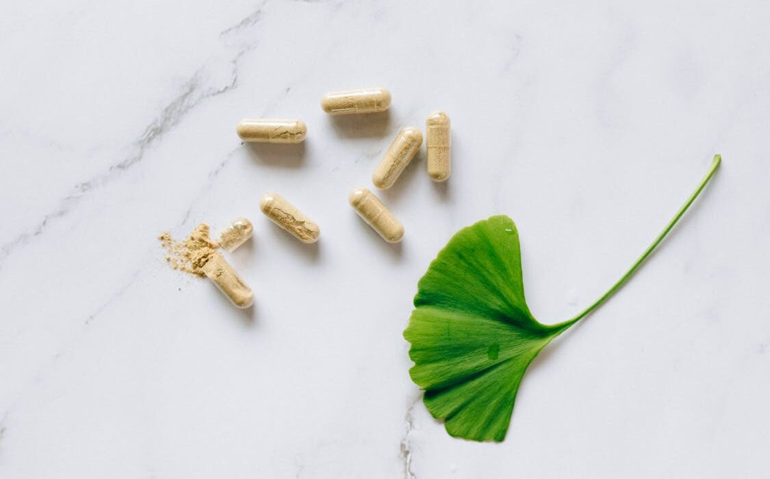 Mucuna pruriens supplement capsules in a bowl