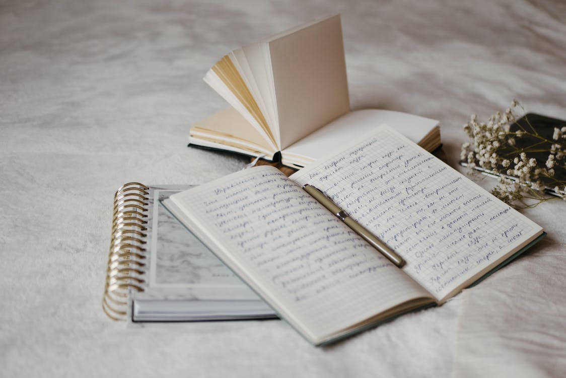 Open notebook with pen for five minute journal vs bullet journal evening routine