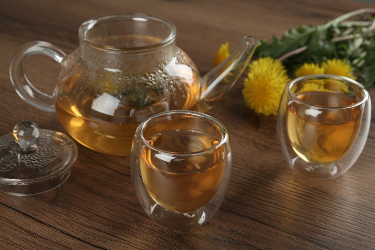 Dandelion root tea for liver health steeping in a glass teapot