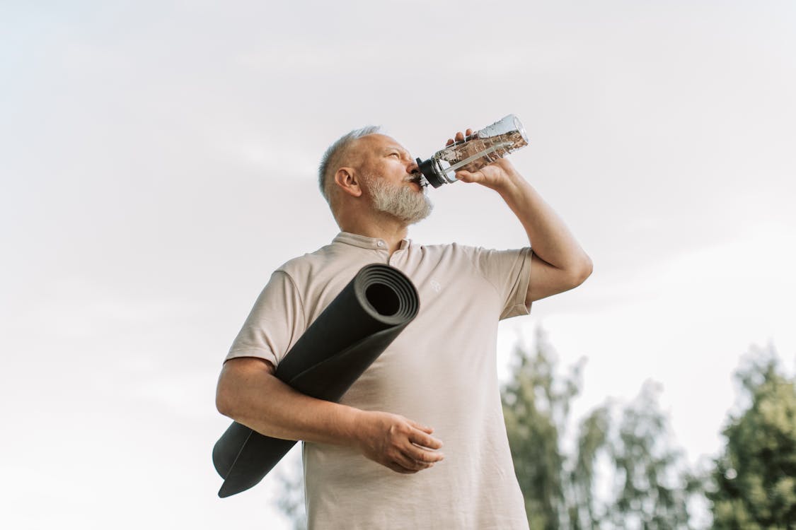 older man hydrating with spermidine supplement for longevity
