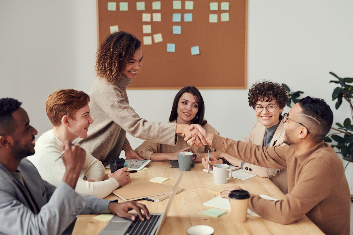 Person raising hand in meeting after using the five second rule for confidence