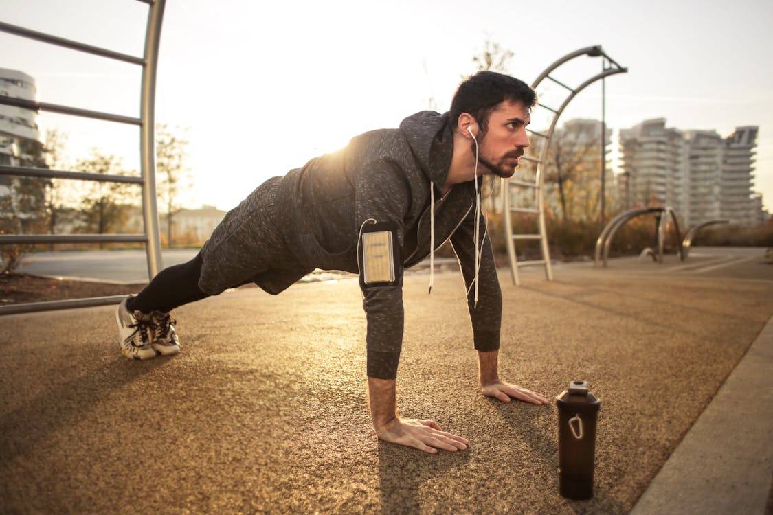 Person listening to podcast while exercising using temptation bundling