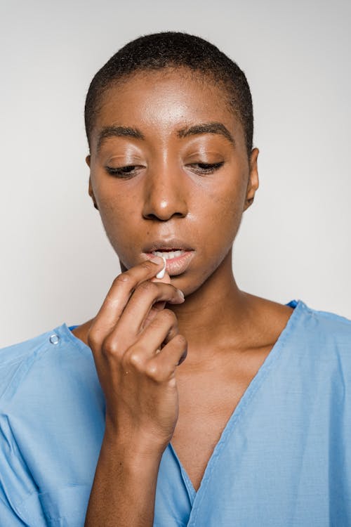 woman taking supplement capsule showing daily wellness routine for beef liver supplements benefits